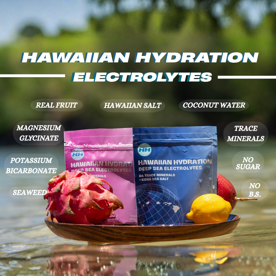 Two packages of Hawaiian Hydration electrolytes on a plate with fruits and sea salt in water.